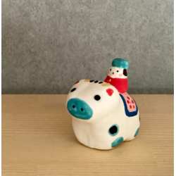 Ox mounted by a small character mini figurine